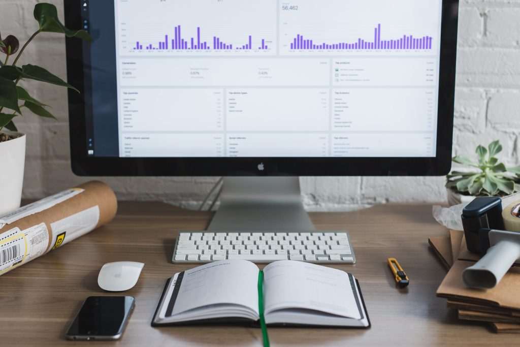 image of computer with notebook to indicate marketing analytics is important for any business