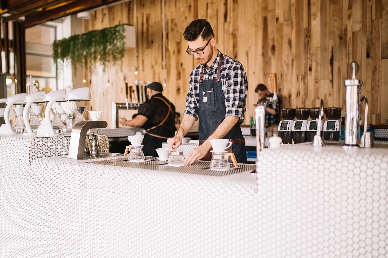 business owner in a coffee shop preparing drinks